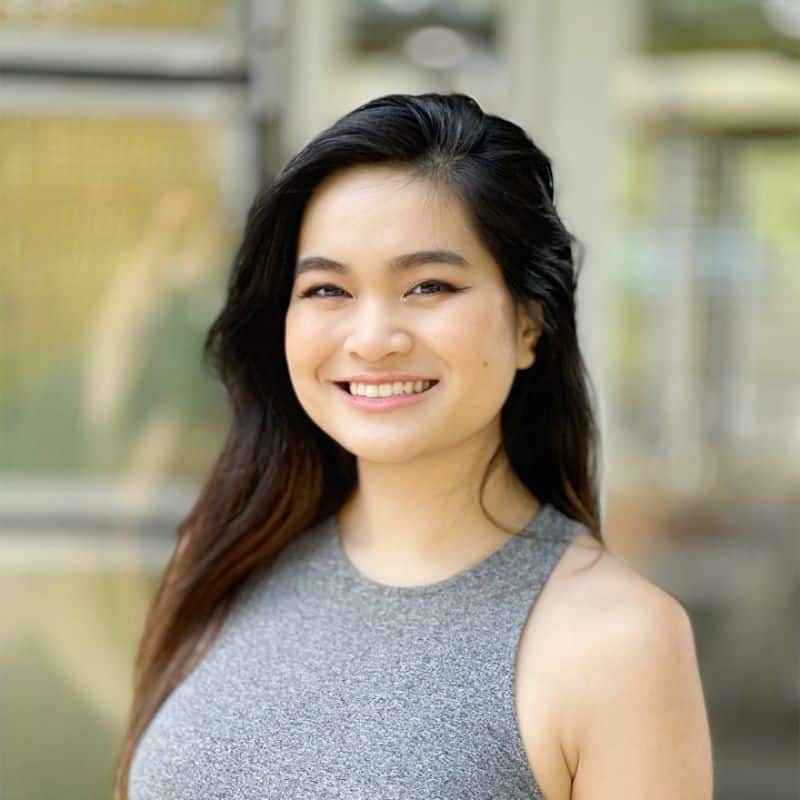 Headshot portrait of Victoria, a team member, smiling outdoors